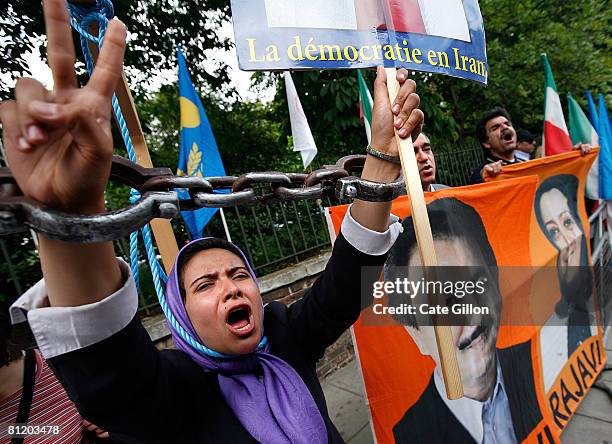 Supporters of the People's Mujahedin Organization of Iran protest with pictures of Maryam Rajavi and her husband Massod Rajavi s, to have the Iranian...