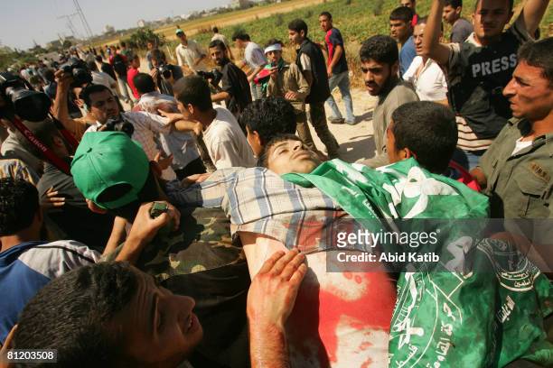 Mortally wounded Abdel Karem Ahel is carried by protestors after being shot by Israeli Defense Forces during a demonstration against the blockade on...