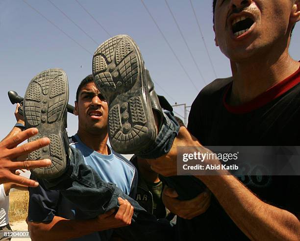 Wounded Palestinian youth is carried by protesters after being shot by Israeli Defense Forces during a demonstration against the blockade on Gaza, on...