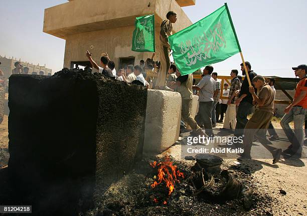 Palestinian protesters holding Hamas flags during a demonstration against the blockade on Gaza, on May 22, 2008 at the Karni Crossing, Gaza. At least...