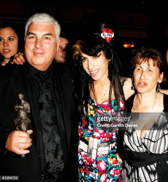 Amy Winehouse, her father Mitch and mother Janis pose with Amy's award for Best Song Musically and Lyrically for 'Love Is A Losing Game' at the 53rd...