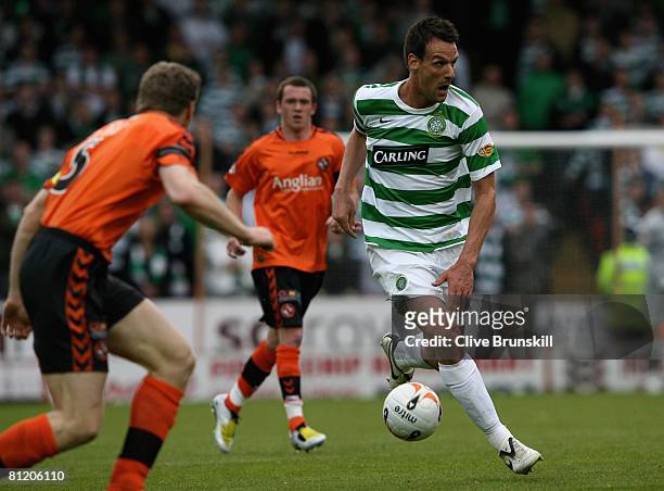Jan Vennegoor of Hesselink of Celtic attempts to run past Darren Dods of Dundee United during the Clydesdale Bank Premier League match between Dundee...