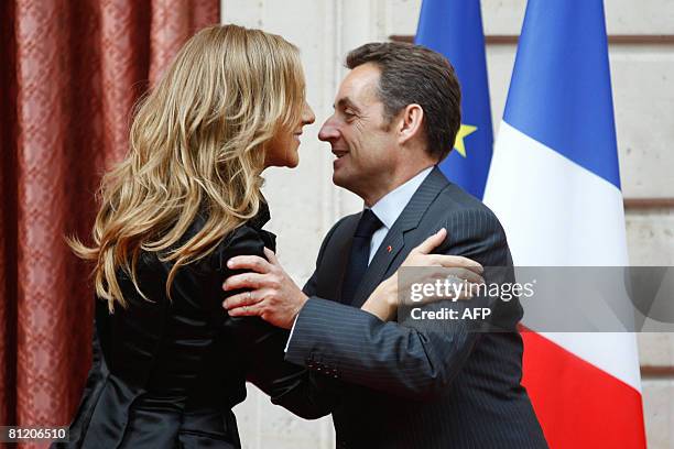 Canadian singer Celine Dion embraces French President Nicolas Sarkozy after she was awarded with the France's Legion d'Honneur during a ceremony at...