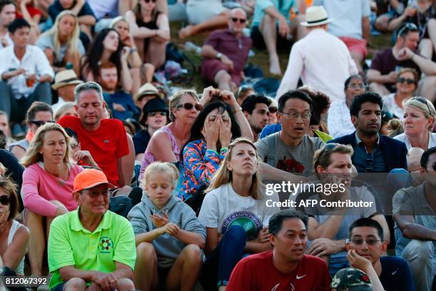 Spectators watch the big screen at Henman Hill as Spain's Rafael Nadal plays against Luxembourg's Gilles Muller in their men's singles fourth round...