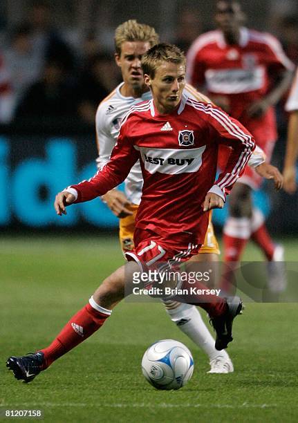 Chris Rolfe of the Chicago Fire move the ball against the Houston Dynamo during the first half at Toyota Park on May 17, 2008 in Bridgeview,...