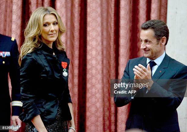 Canadian singer Celine Dion is congratulated by French President Nicolas Sarkozy after she was awarded with France's Legion d'Honneur during a...