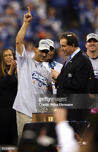 Tony Dungy, Head Coach of the Indianapolis Colts, with Jim Nantz at the trophy ceremony after the AFC Championship game between the New England...