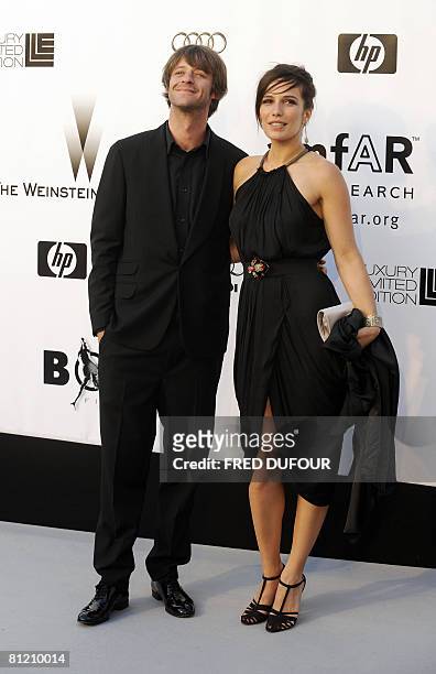 French actors Zoe Felix and Benjamin Rolland pose as they arrive to attend the amfAR's Cinema Against AIDS 2008 benefit held at Le Moulin de Mougins...