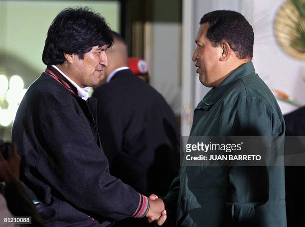 Venezuelan President Hugo Chavez speaks with his Bolivian counterpart Evo Morales, at Miraflores presidential palace in Caracas on May 22, 2008....