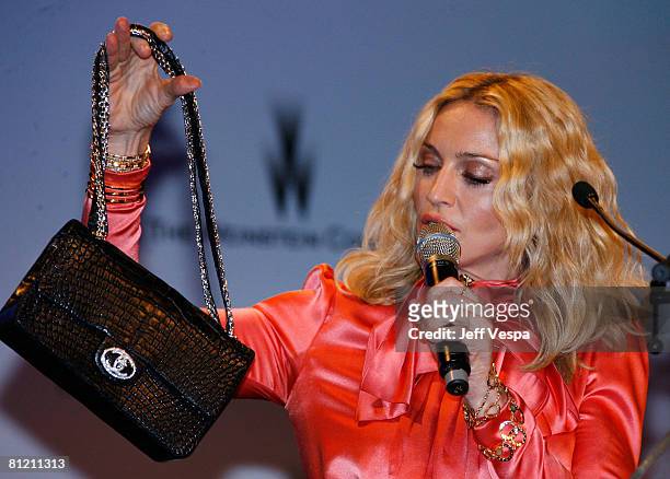 Singer Madonna speaks during amfAR's Cinema Against AIDS 2008 auction held at Le Moulin de Mougins during the 61st International Cannes Film Festival...
