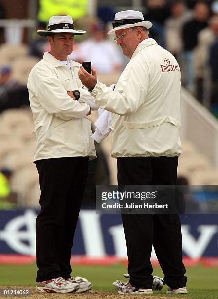 Umpire Simon Taufel and Darrell Hair discuss the light during the first day of the 2nd npower Test Match between England and New Zealand at Old...