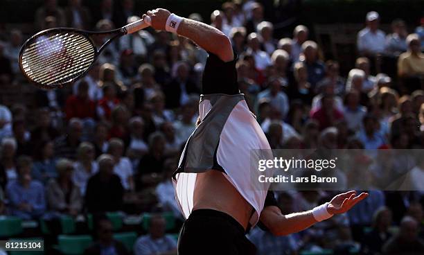 Dmitry Tursunov of Russia serves during his double match with team mate Mikhail Youzhny during their match against Christopher Kas and Philipp...