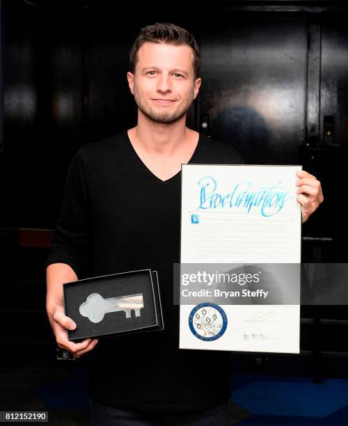 Magician Mat Franco holds a ceremonial key to the Las Vegas Strip and a proclamation presented to him as part of the ceremony renaming the showroom...