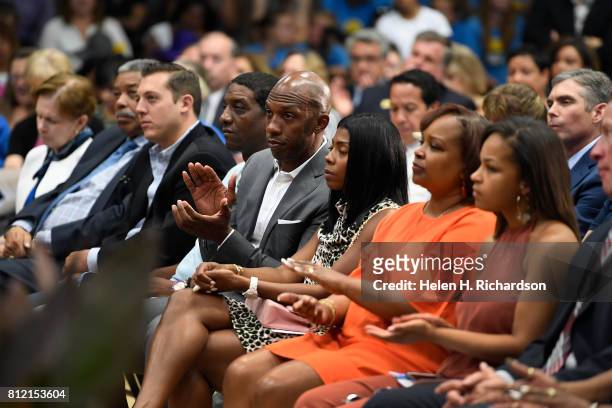 Former NBA star Chauncey Billups, fourth from right, sits with his wife Piper, third from right, as they listen to Denver Mayor Michael Hancock give...