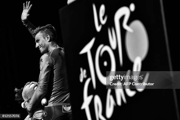 Germany's Marcel Kittel waves as he leaves the podium after celebrating his green jersey of best sprinter at the end of the 213,5 km seventh stage of...