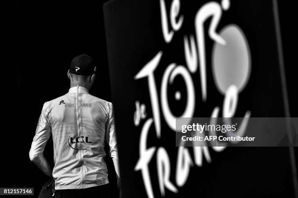 Great Britain's Christopher Froome leaves the podium after celebrating his overall leader yellow jersey at the end of the 213,5 km seventh stage of...