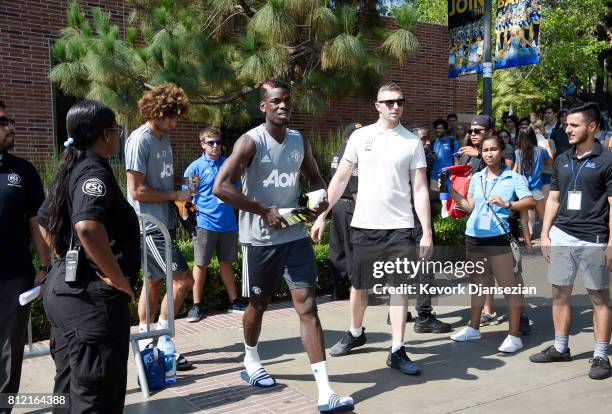 Marouane Fellaini and Paul Pogba of Manchester United arrive for a training session for Tour 2017 at UCLA's Drake Stadium July 10 in Los Angeles,...