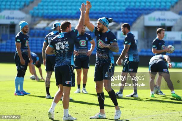 Wade Graham and Blake Ferguson high five during the New South Wales Blues State of Origin training session at Cbus Super Stadium on July 11, 2017 in...