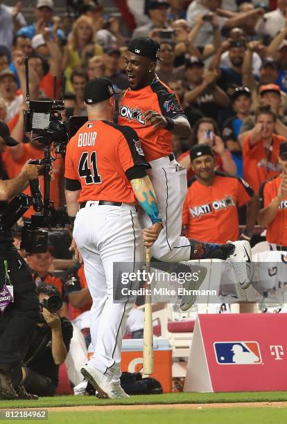 Justin Bour of the Miami Marlins celebrates with Marcell Ozuna of the Miami Marlins and the National League during the T-Mobile Home Run Derby at...