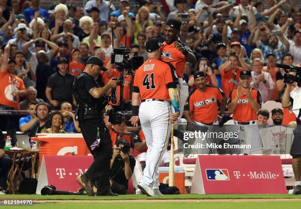 Justin Bour of the Miami Marlins celebrates with Marcell Ozuna of the Miami Marlins and the National League during the T-Mobile Home Run Derby at...