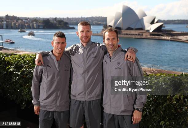 Laurent Koscielny, Per Mertesacker and Petr Cech pose in front of the Sydney Opera House during an Official Welcome to Sydney for Arsenal FC at...
