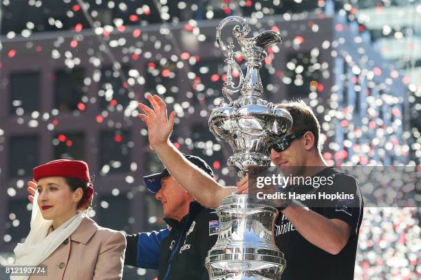 Helmsman, Peter Burling, holds the Americas Cup while CEO, Grant Dalton, looks on during the Team New Zealand Americas Cup Wellington Welcome Home...