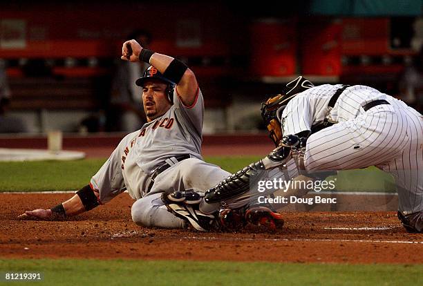 Catcher Matt Treanor of the Florida Marlins can't block the plate as Aaron Rowand of the San Francisco Giants scores on a double by Rich Aurilia in...