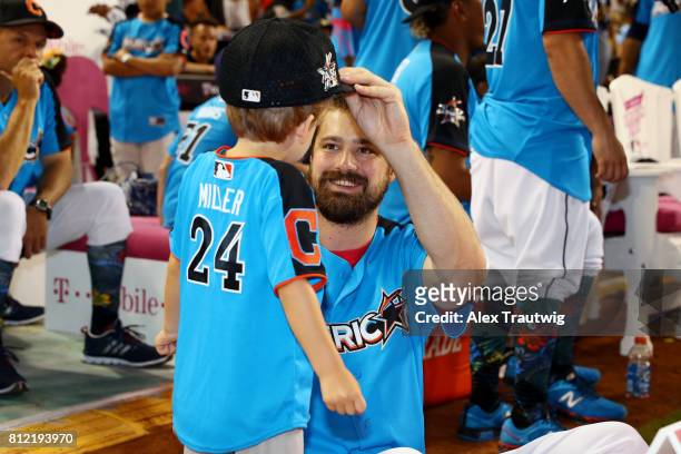 Andrew Miller of the Cleveland Indians plays with his son during the 2017 T-Mobile Home Run Derby at Marlins Park on Monday, July 10, 2017 in Miami,...