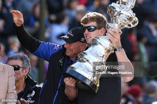 Helmsman, Peter Burling, holds the Americas Cup while CEO, Grant Dalton, looks on during the Team New Zealand Americas Cup Wellington Welcome Home...