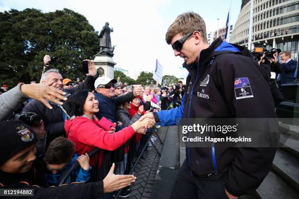 Helmsman, Peter Burling, speaks to fans during the Team New Zealand Americas Cup Wellington Welcome Home Parade on July 11, 2017 in Wellington, New...
