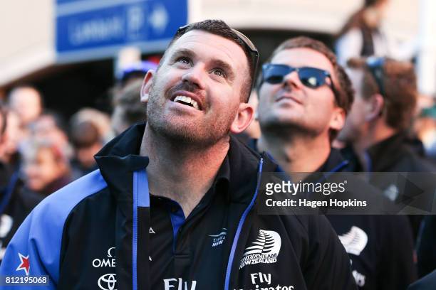 Cyclists, Joe Sullivan and Simon van Velthooven look on during the Team New Zealand Americas Cup Wellington Welcome Home Parade on July 11, 2017 in...