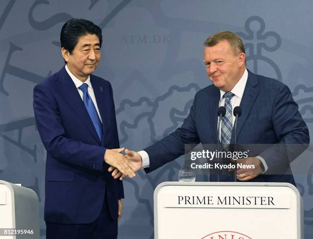 Japanese Prime Minister Shinzo Abe and his Danish counterpart Lars Loekke Rasmussen shake hands after a joint press conference in Copenhagen on July...