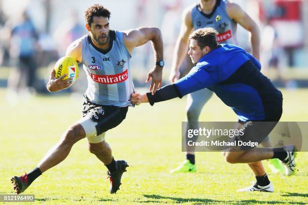 Daniel Wells runs with the ball away from Ben Kennedy during a Collingwood Magpies AFL training at the Holden Centre on July 11, 2017 in Melbourne,...