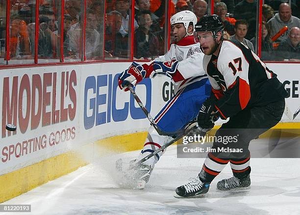 Jeff Carter of the Philadelphia Flyers skates against Roman Hamrlik of the Montreal Canadiens during Game 4 of the Eastern Conference Semifinals of...