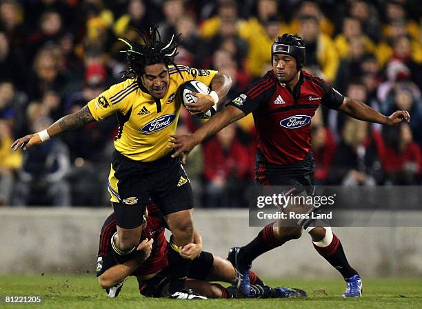 Ma'a Nonu of the Hurricanes is tackled by Tim Bateman and Mose Tuiali'i of the Crusaders defence during the Super 14 semi-final match between the...