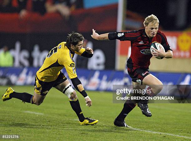 Canterbury Crusaders player Scott Hamilton pushes off Wellington Hurricanes player Cory Jane in their Super 14 rugby semi-final match at AMI Stadium...