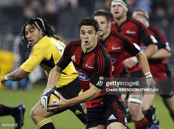 Dan Carter of the Canterbury Crusaders runs with the ball against the Wellington Hurricanes in their Super 14 rugby semi-final match at AMI Stadium...