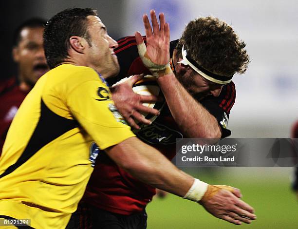 Kieran Read of the Crusader is tackled by Jeremy Thrush of the Hurricanes during the Super 14 semi-final match between the Crusaders and the...