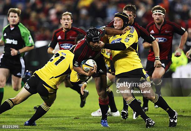 Mose Tuialai'i of the Crusader is tackled by the Hurricanes defence during the Super 14 semi-final match between the Crusaders and the Hurricanes at...