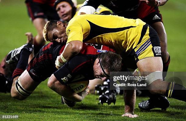 Brad Thorn of the Crusaders ducks under the tackle of Jerry Collins of the Hurricanes during the Super 14 semi-final match between the Crusaders and...