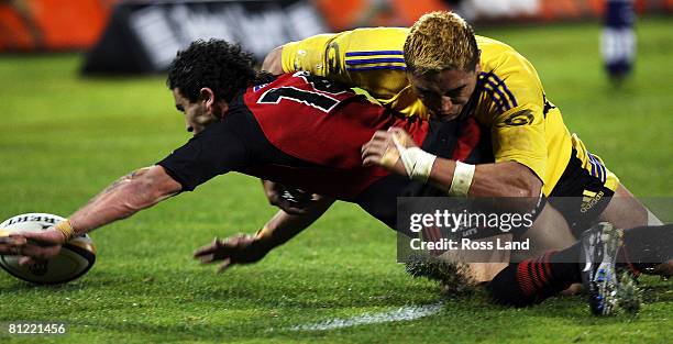 Jerry Collins of the Hurricanes tackles Kade Poki of the Crusaders during the Super 14 semi-final match between the Crusaders and the Hurricanes at...
