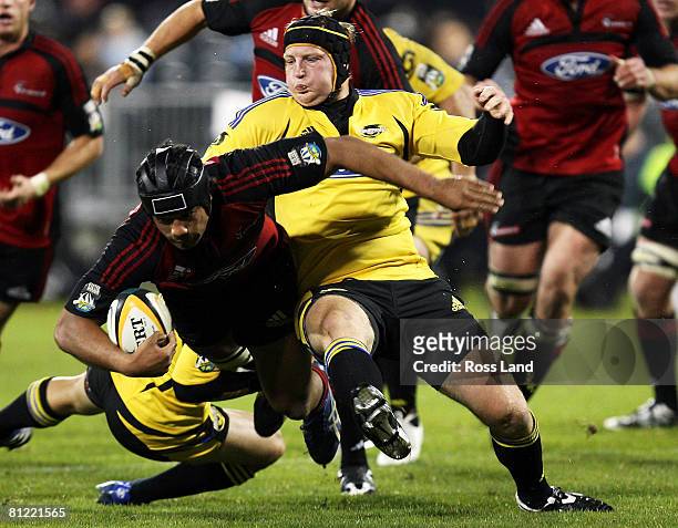 Mose Tuiali'i of the Crusaders is tackled y Thomas Waldrom of the Hurricanes during the Super 14 semi-final match between the Crusaders and the...