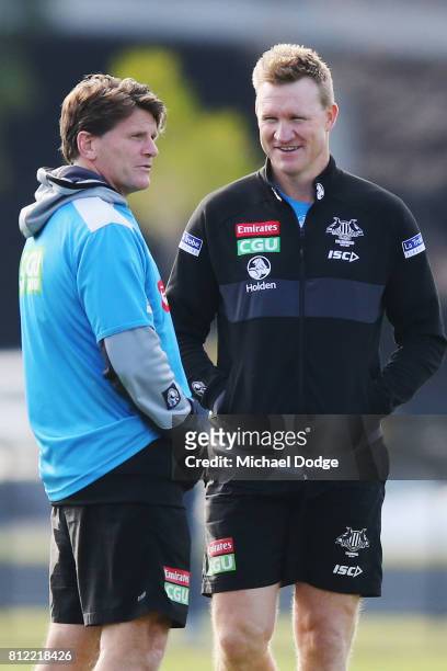 Collingwood Magpies AFL coach Nathan Buckley speaks to assistant coach Robert Harvey during a Collingwood Magpies AFL training at the Holden Centre...