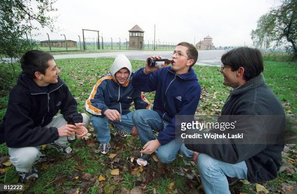 Young people from Oswiecim drink beer April 22, 2002 close to the former concentration camp in Auschwitz, Poland. Auschwitz, which is known for one...