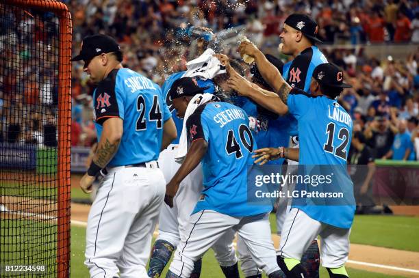 Aaron Judge of the New York Yankees is mobbed by teammates after winning the 2017 T-Mobile Home Run Derby at Marlins Park on Monday, July 10, 2017 in...