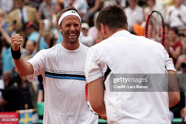 Robert Lindstedt of Sweden celebrates with team mate Robin Soderling after winning the final of the ARAG World Team Cup at the Rochusclub on May 24,...