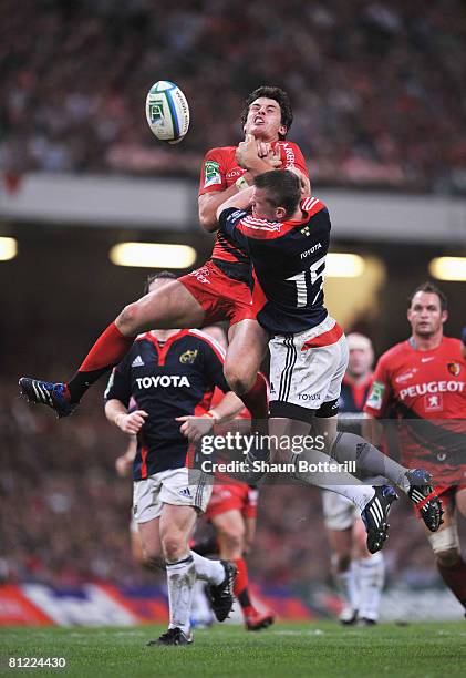 Yannick Jauzion of Toulouse and Denis Hurley of Munster challenge for the high ball during the Heineken Cup Final between Munster and Toulouse at the...