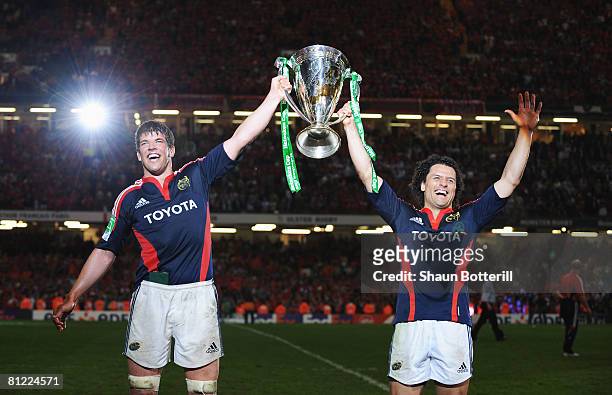 Donncha O'Callaghan and Doug Howlett of Munster celebrate with the triophy following victory in the Heineken Cup Final between Munster and Toulouse...