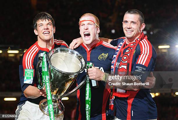 Donncha O'Callaghan, Paul O'Connell and Alan Quinlan of Munster celebrate with the trophy following victory in the Heineken Cup Final between Munster...