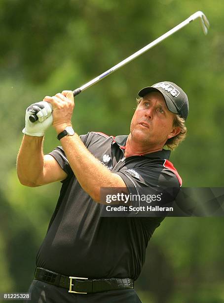 Phil Mickelson watches his tee shot to the fourth green during the third round of the Crown Plaza Invitational at the Colonial Country Club on May...